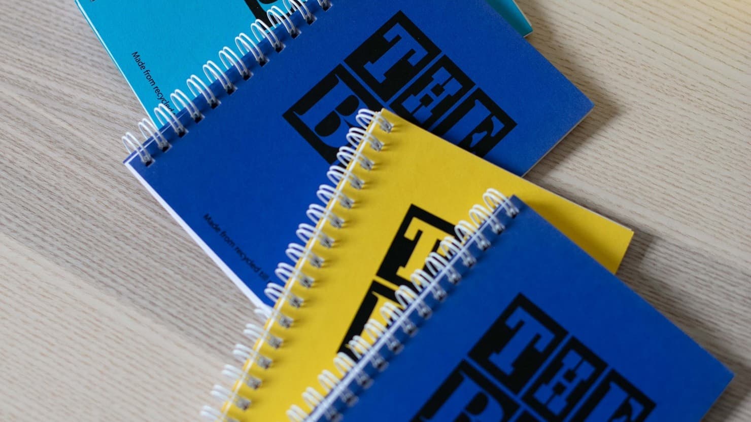 The Box notepads in yellow, blue and turquoise
