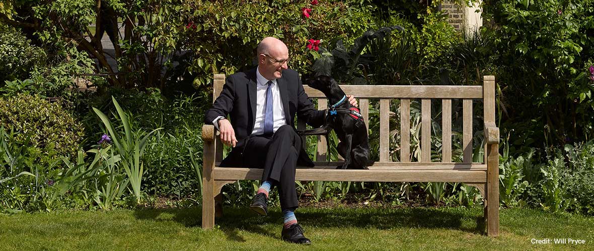 Peter and Bertie sitting on a bench in the Charterhouse grounds.