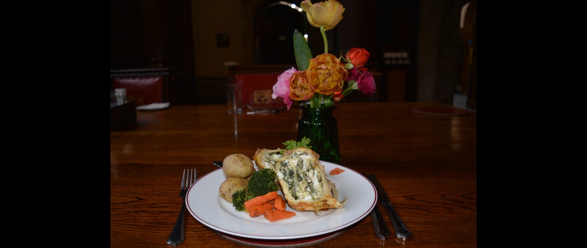 Spanakopita and veg on a plate in the Great Hall