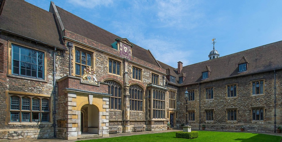 view across a courtyard towards grand buildings made from stone and brick
