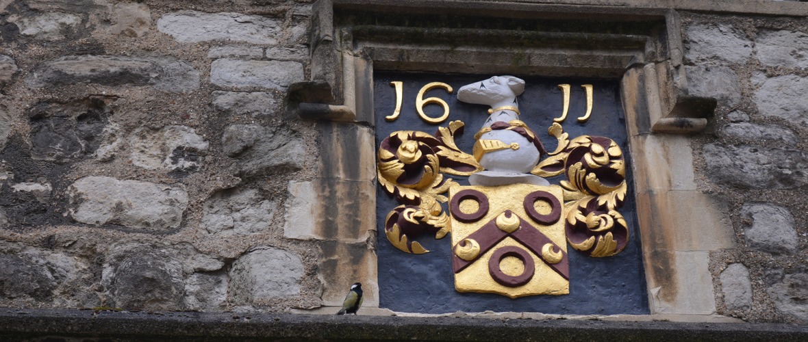 the date 1611 over a crest and coat of arms