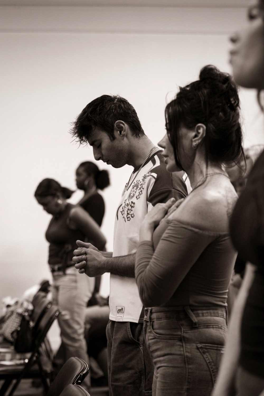 People praying during worship at Love Church