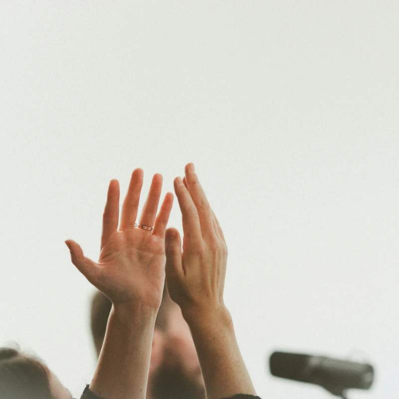 persons hand on white textile