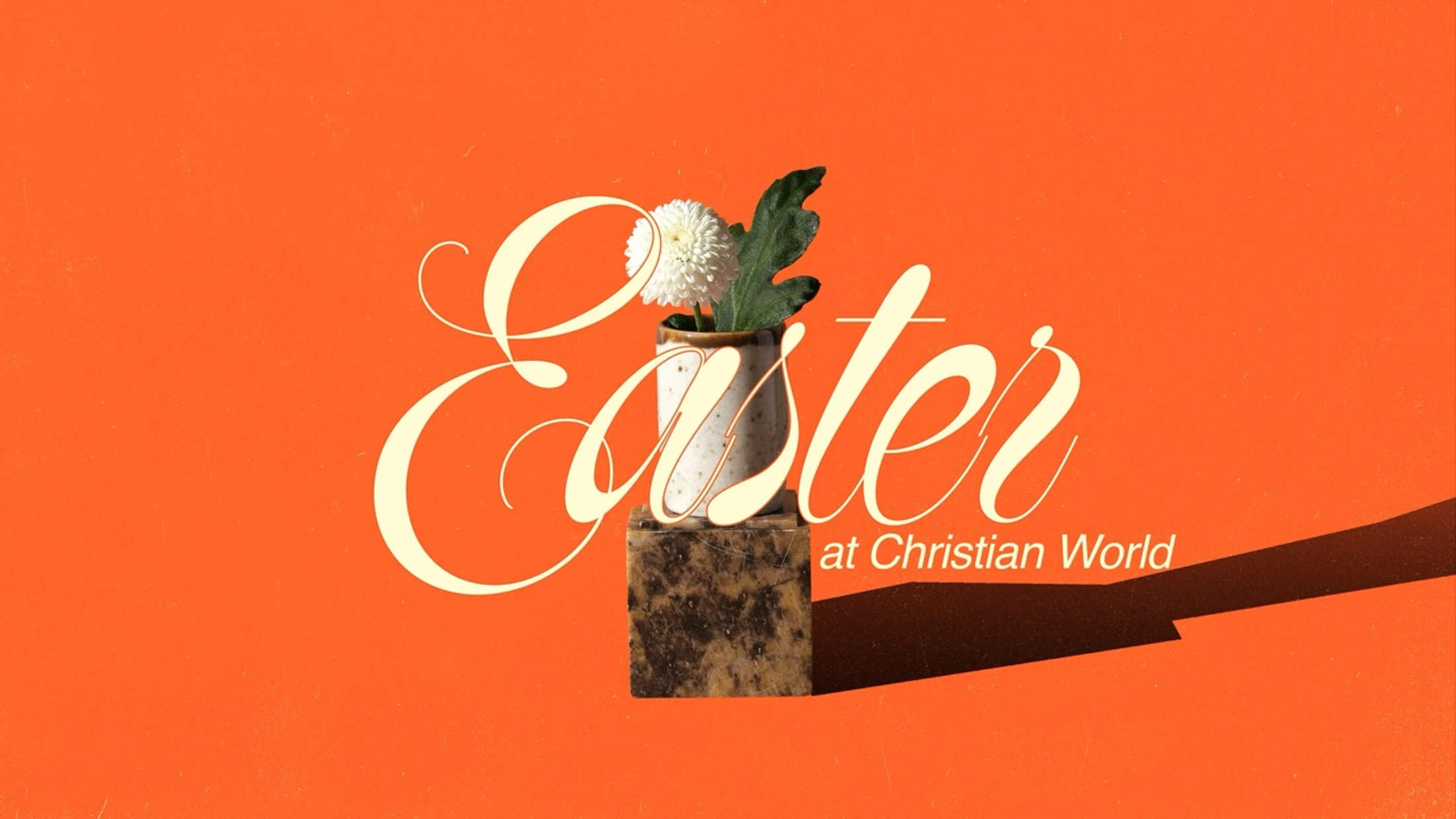 The word 'Easter' in elegant cream cursive text over a vase with a white flower on a marble block, all against a bright orange background.
