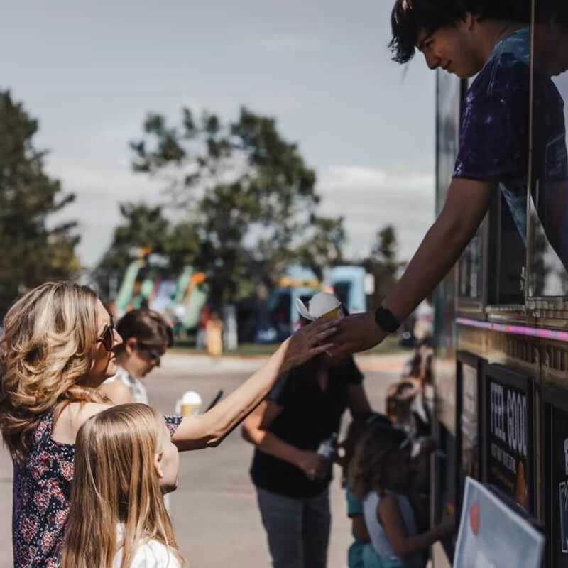 Volunteers serving food at evangelical church community service event near Littleton area