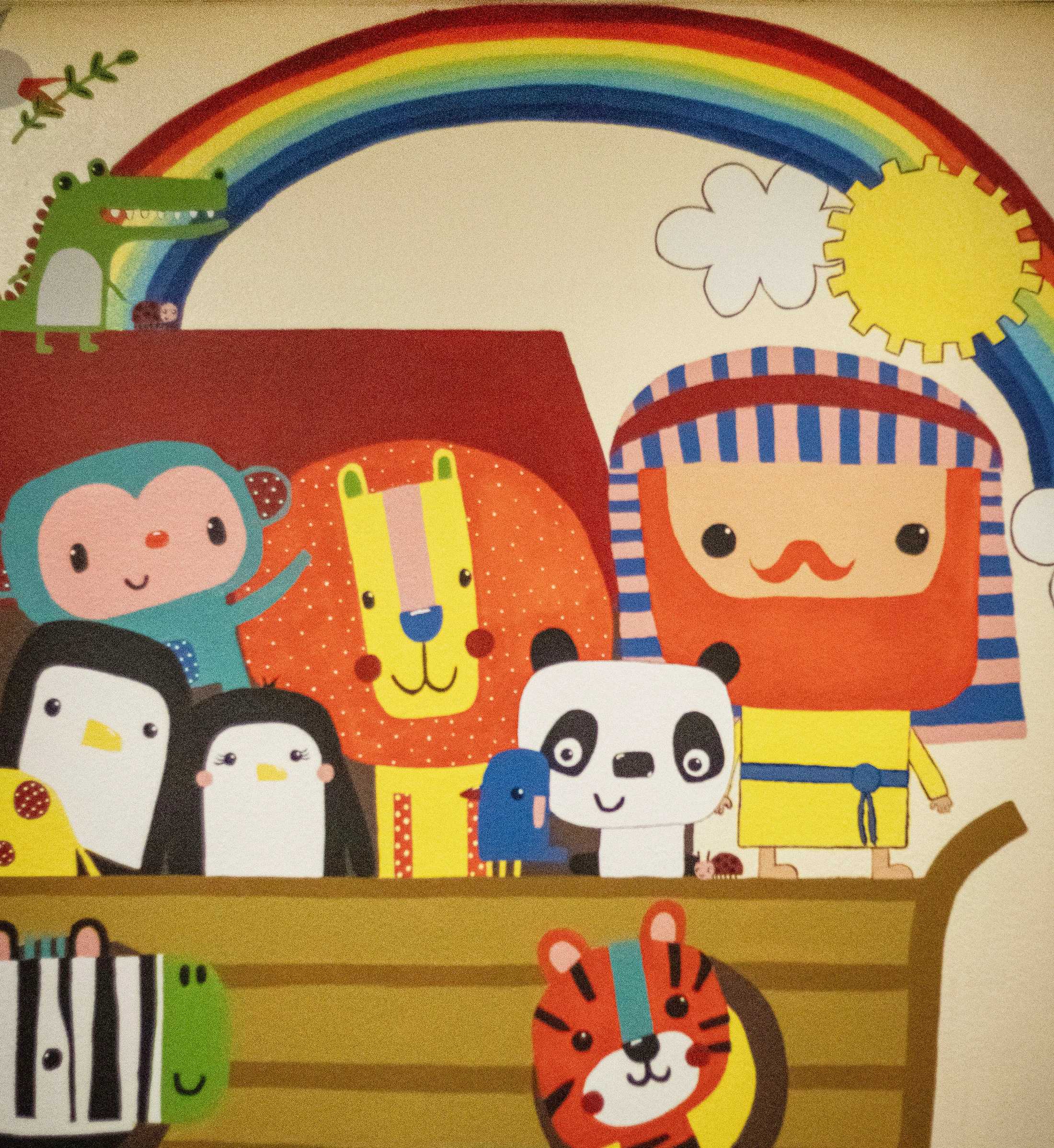 A cute cartoon illustration of Noah's Ark filled with pairs of animals like lions, pandas, and penguins. Noah stands with them under a bright rainbow.
