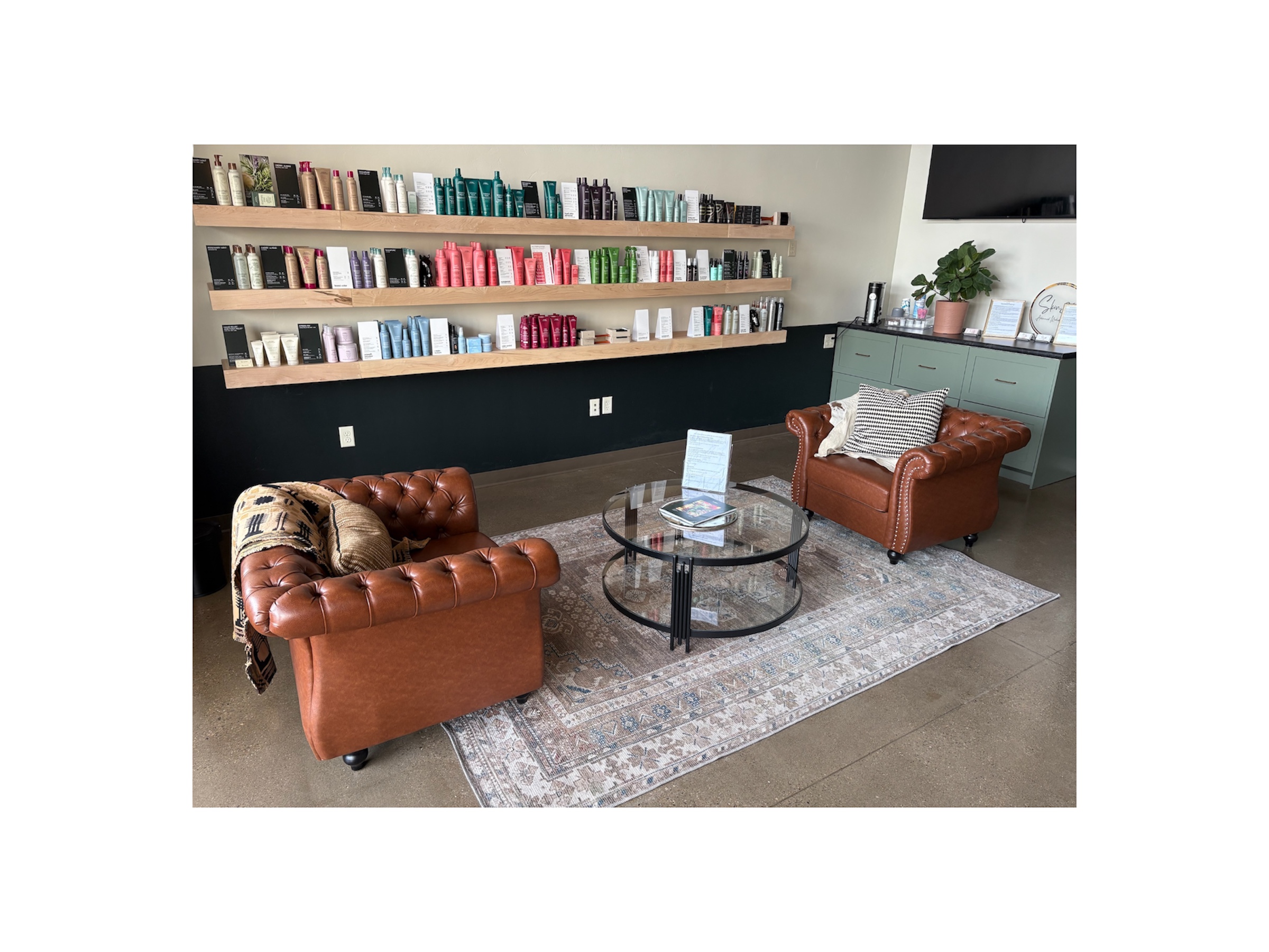 Spacious Green Bay hair salon with leather seating, lighted styling stations, and modern decor.