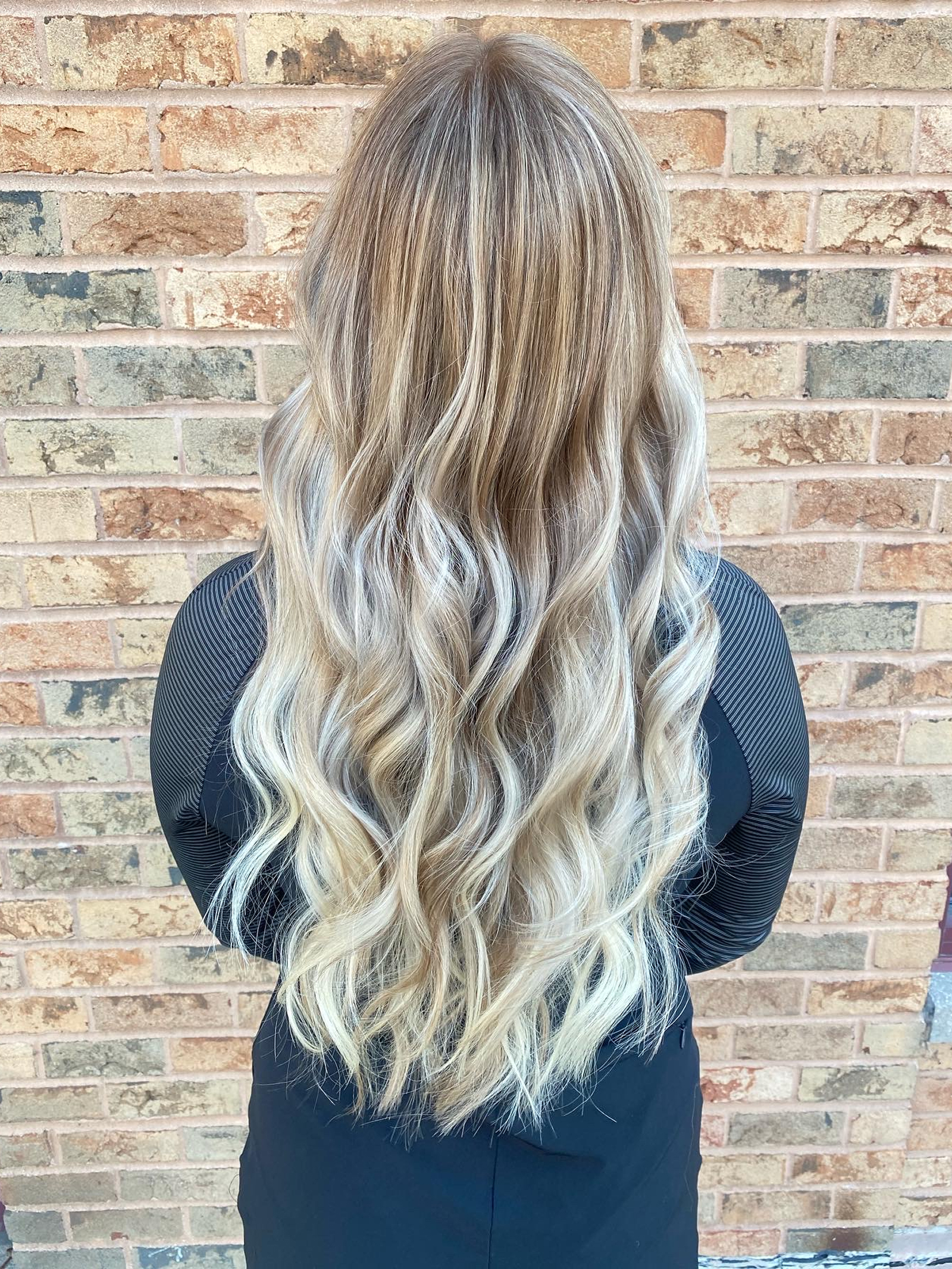 Blended blonde long waves styled by Lauren Prost at The Collective salon in Green Bay, Wisconsin.