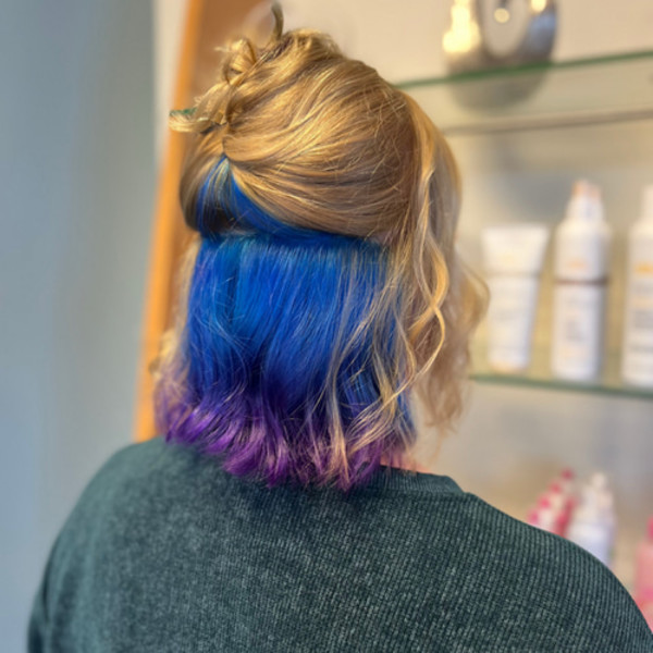 Blonde wavy hair with vivid blue and purple underlayer by Green Bay hair stylist Kassandra Simonar.