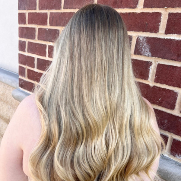 Long blonde balayage with soft waves and shadow root by Green Bay hair stylist Kassandra Simonar.