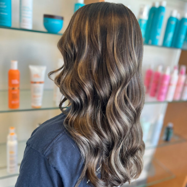 Long brunette hair with soft balayage highlights and loose waves by Green Bay stylist Kassandra Simonar.