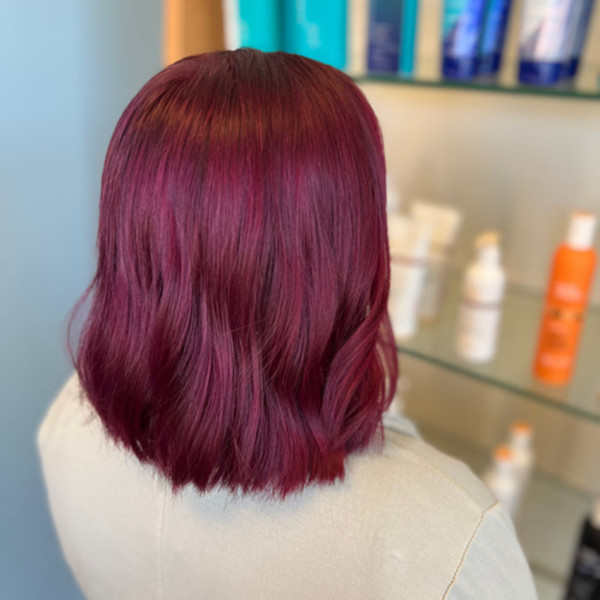 Shoulder-length hair with rich magenta color created by Green Bay WI stylist Kassandra Simonar.