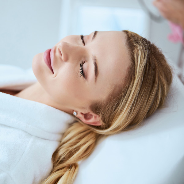 Woman relaxing while receiving beauty services
