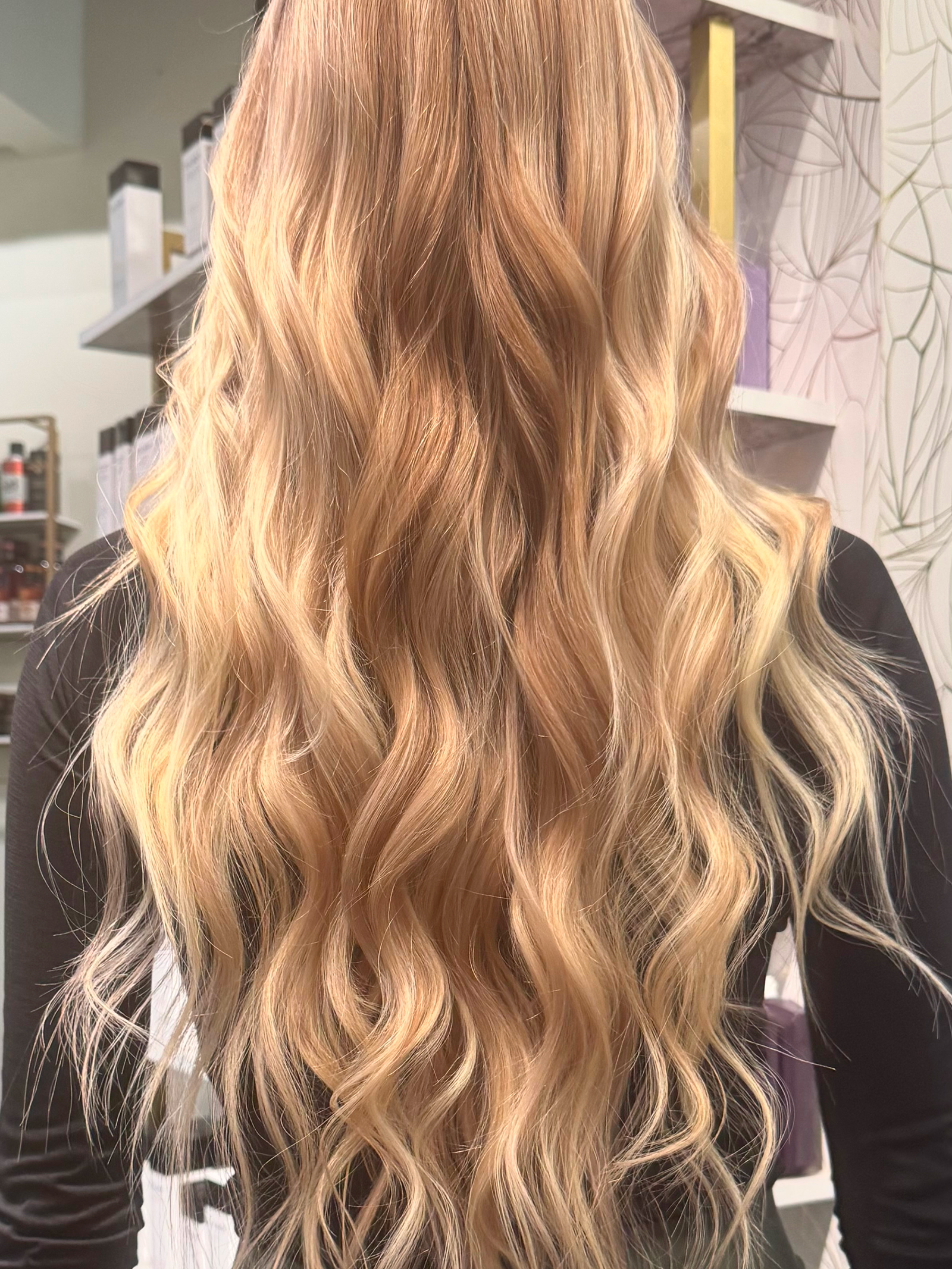 Golden blonde wavy hair styled by Lauren Prost at The Collective salon in Green Bay, Wisconsin.