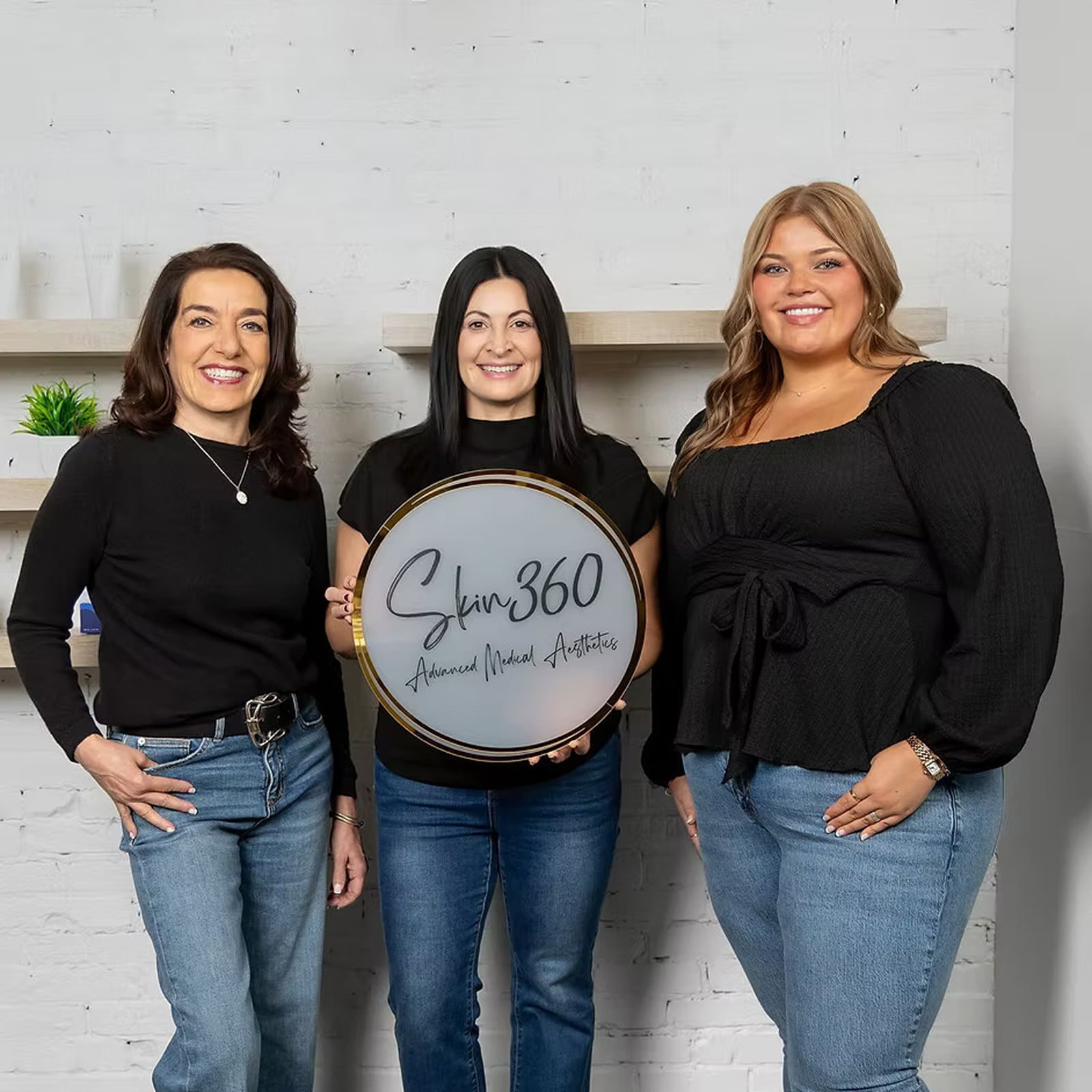 Skin360 team together holding Skin360 sign