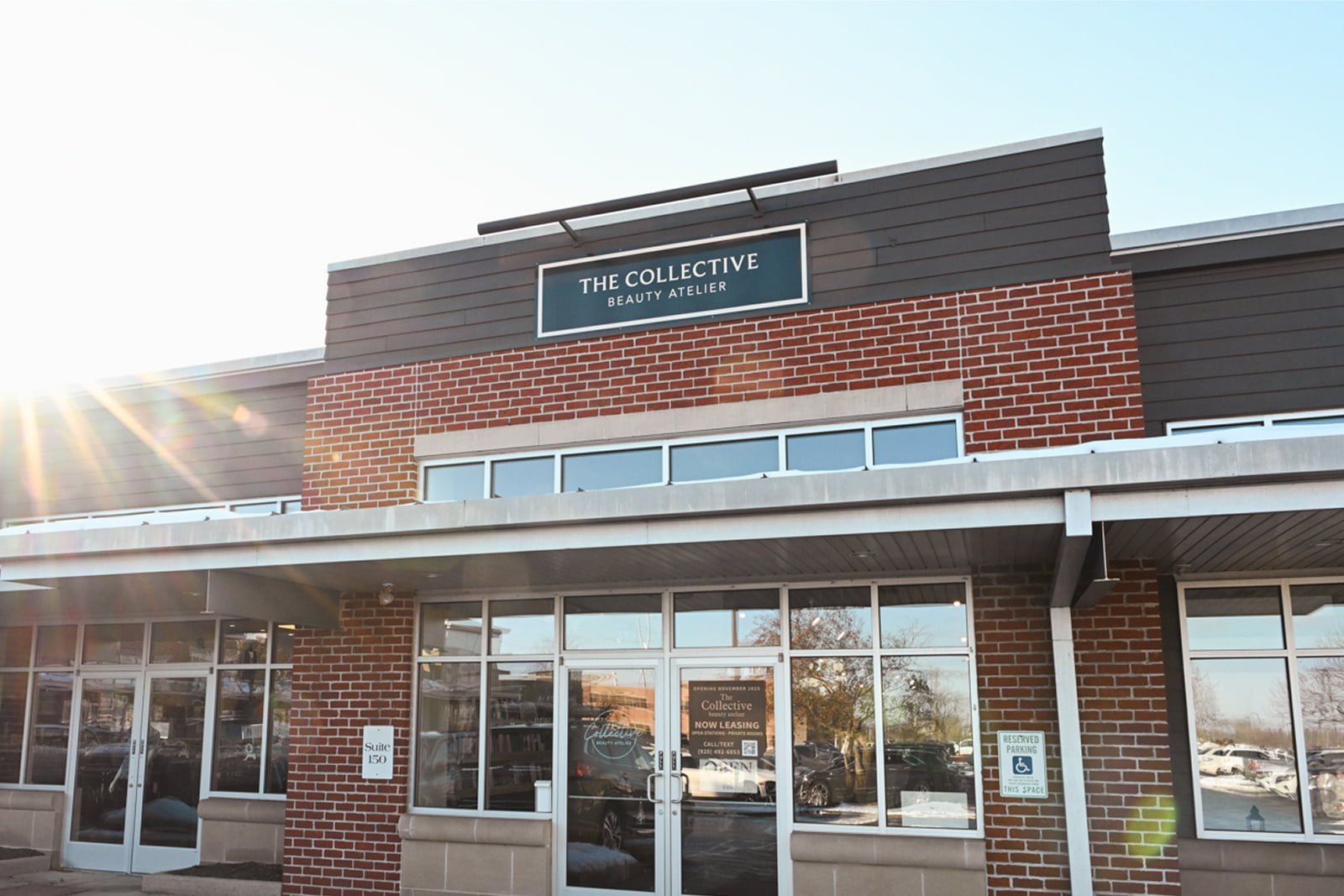 Hair salon in Green Bay WI with modern styling stations, reception desk, and polished concrete floors.