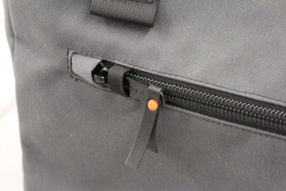 The heavy front zipper with the orange button