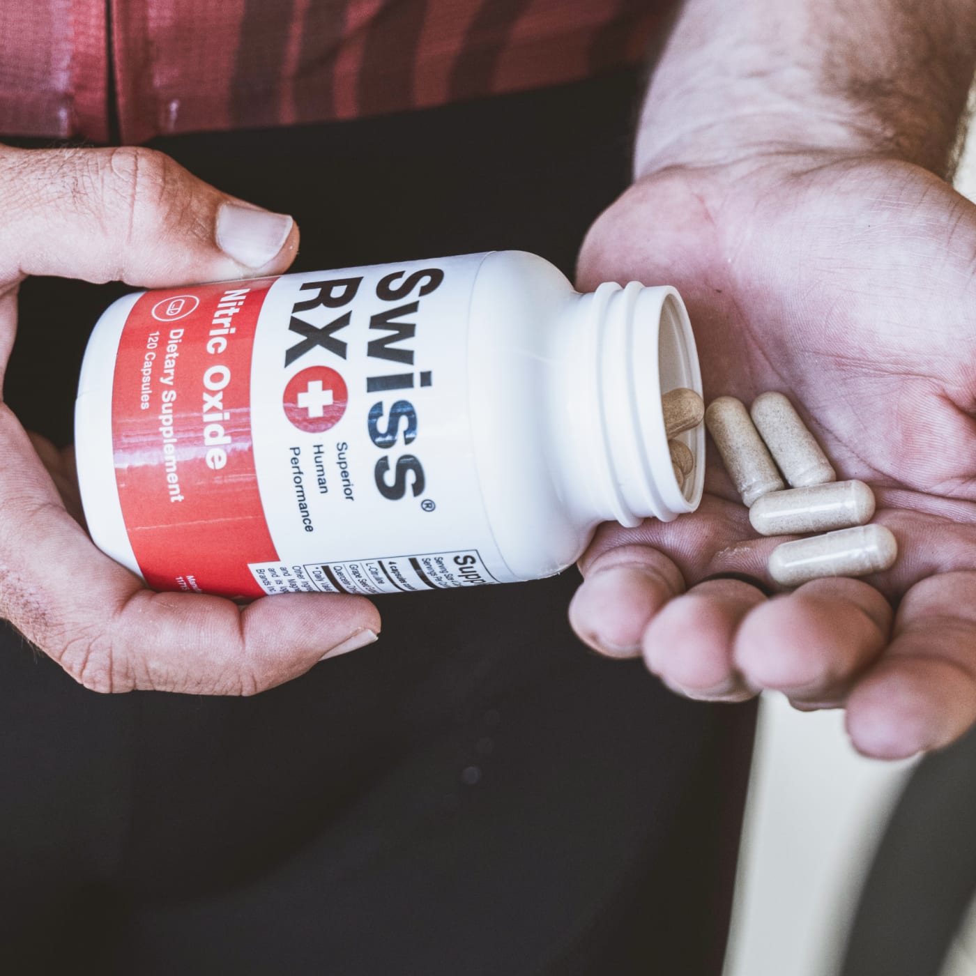 Close-up of SwissRX Nitric Oxide capsules poured into hand