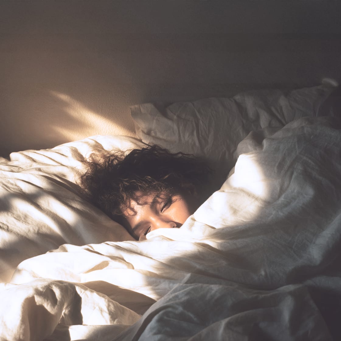 feedcreative a person wrapped tightly in white bedding 1x1