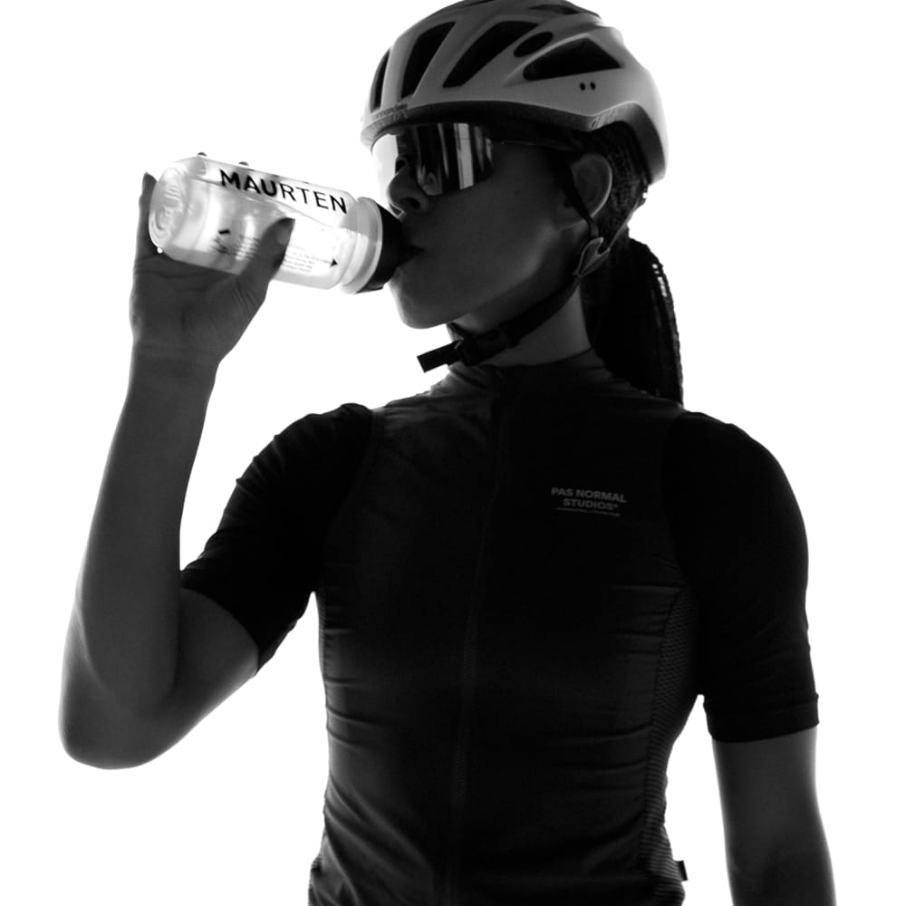 Cyclist drinking from a Maurten water bottle — science-based sports hydration for endurance athletes
