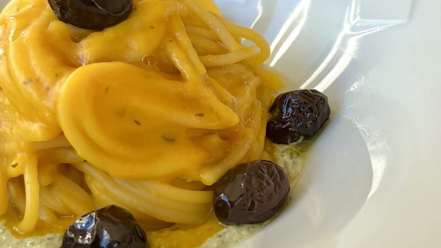 Spaghetti con crema di zucca, pesto cremoso di semi di zucca e olive in agrodolce