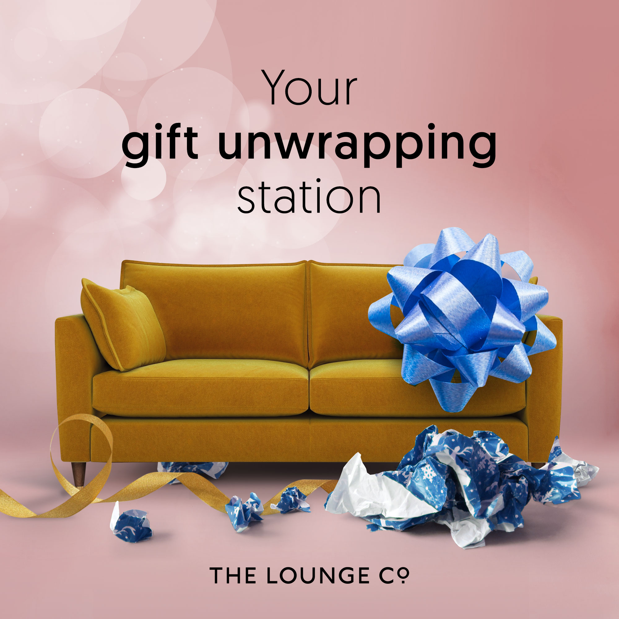 Unwrapping Christmas presents on the sofa