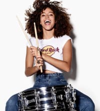 Model playing drums in Hard Rock t-shirt