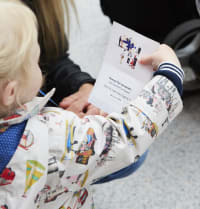 Child holding train wi-fi password card