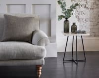 Grey fabric sofa with beige corner table