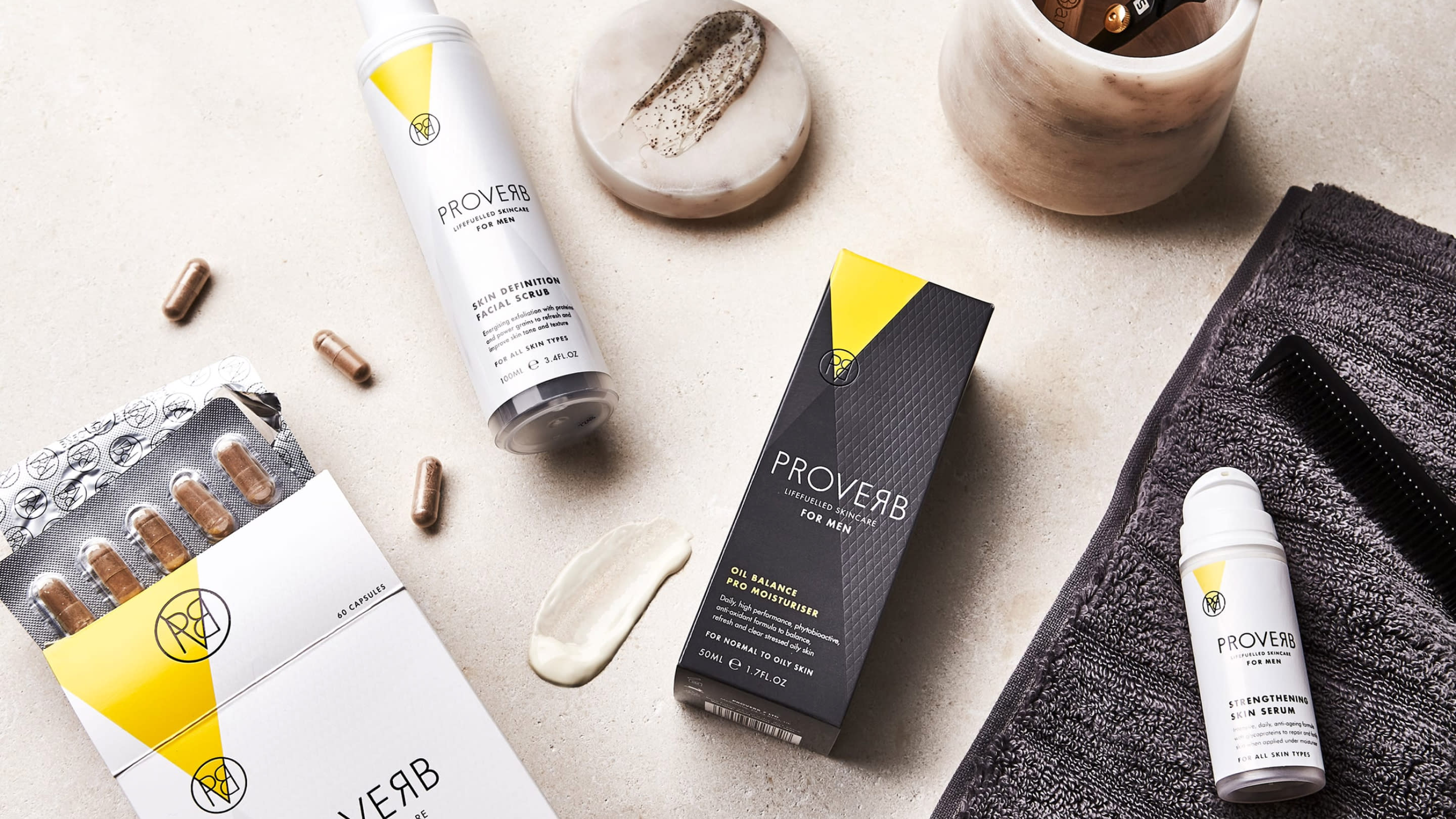Packaging of Proverb's facial skincare products, including the 'Skin definition facial scrub' and 'Oil balance pro moisturiser