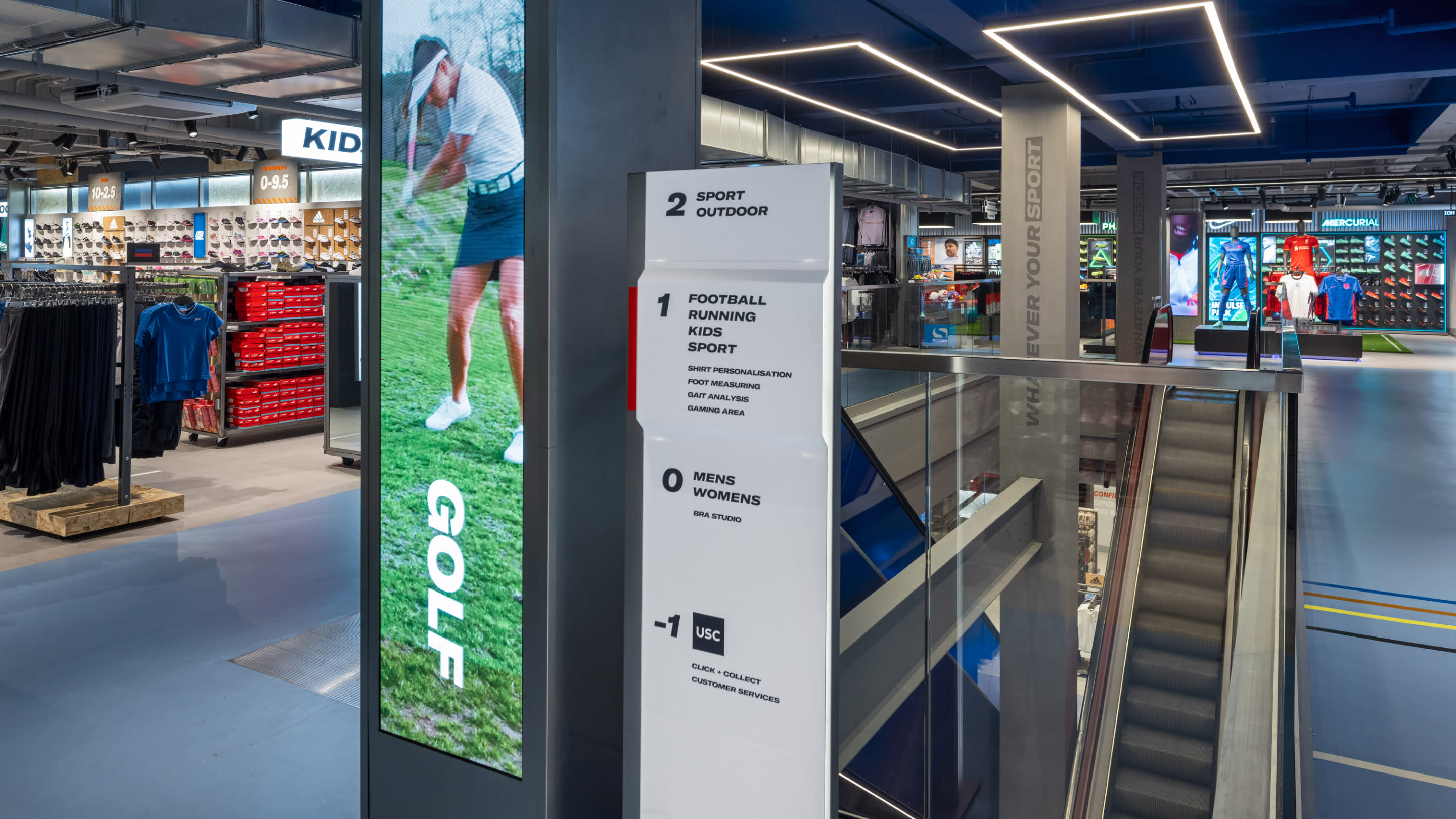 A plinth and digital screen inside Sports Direct with floor layout information and signage