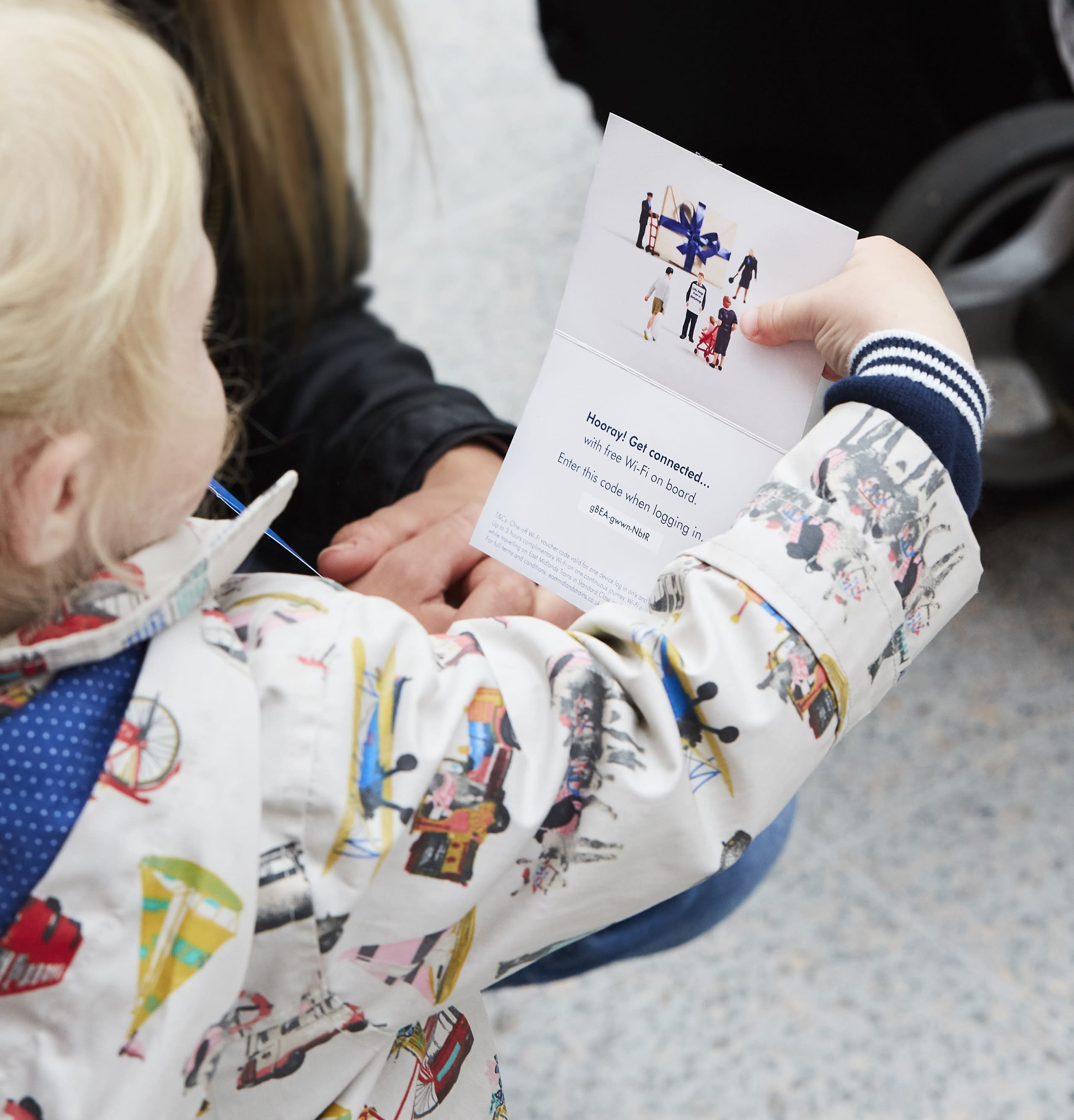 Child holding train wi-fi password card