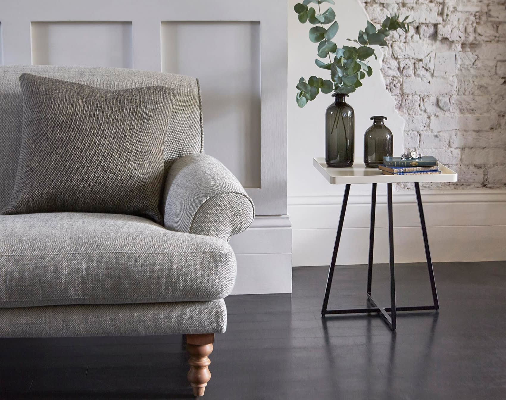 Grey fabric sofa with beige corner table