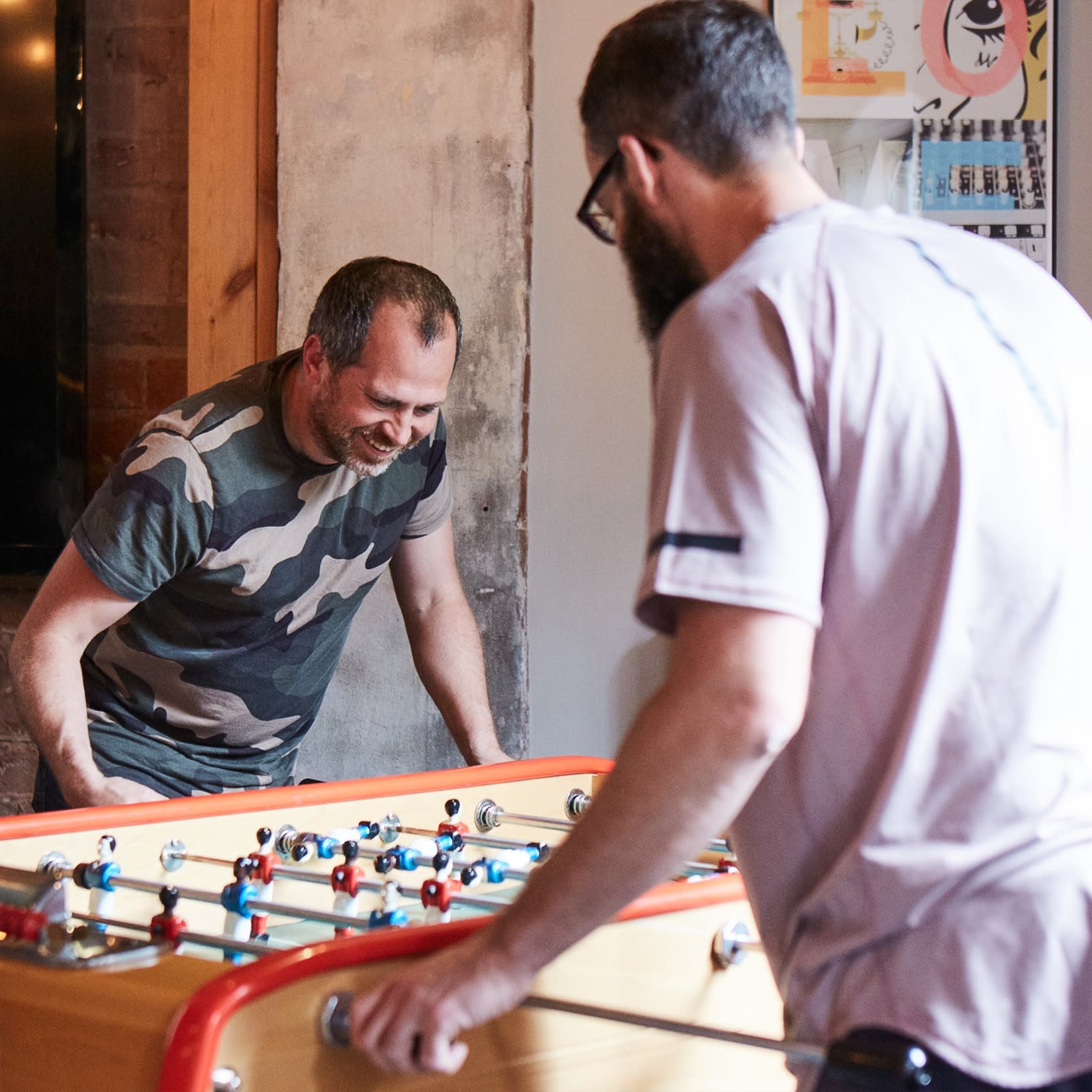 2 men playing table football