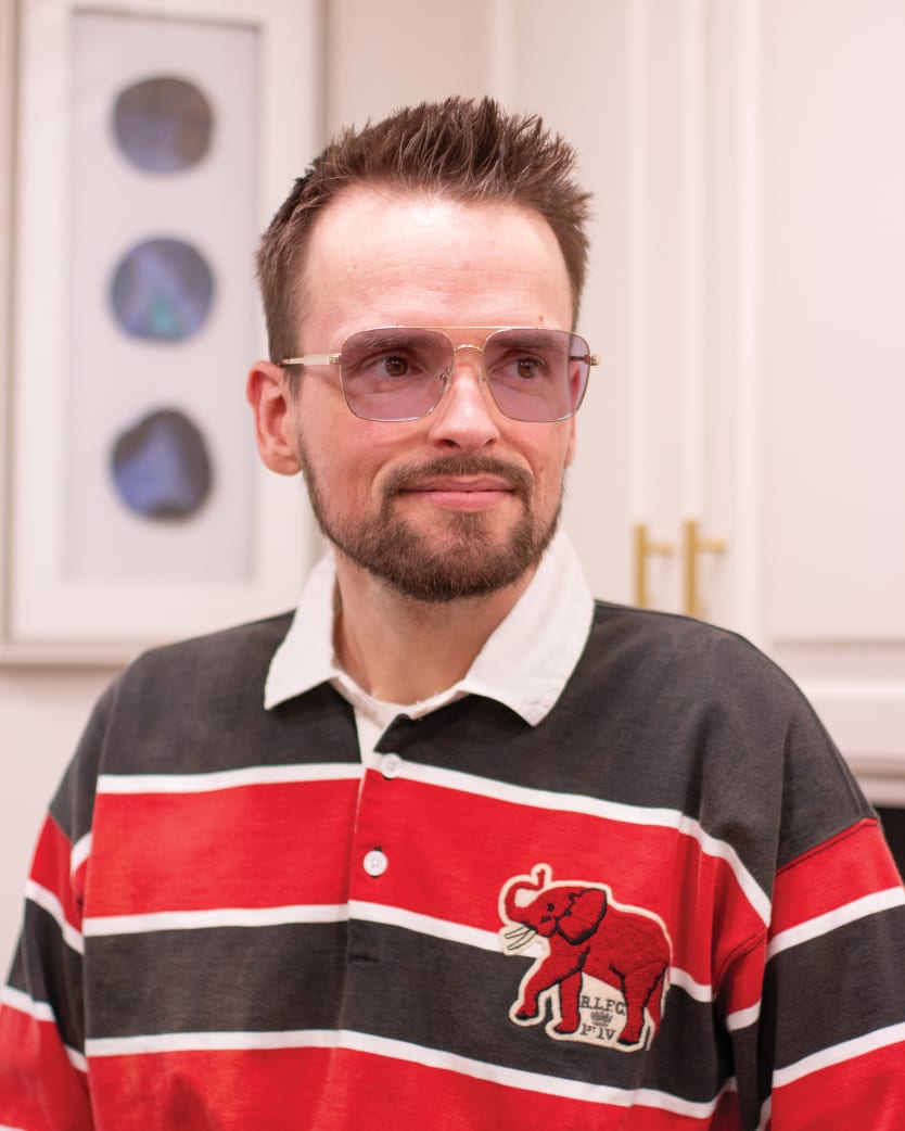 Man wearing TheraSpecs therapeutic glasses with FL-Blend lenses for glaucoma and artificial light
