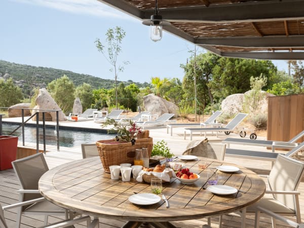 The pool area extends to the dining and outdoor kitchen area.