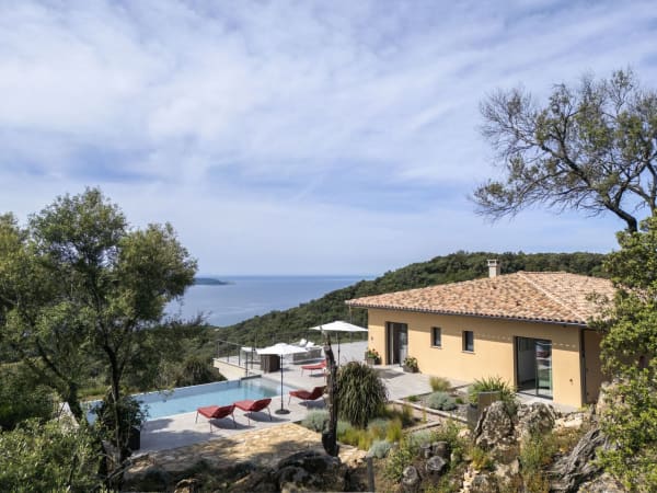 The house, the pool terrace, and views out to sea.