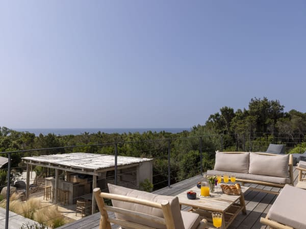 The comfortably furnished decked terrace above the pool.