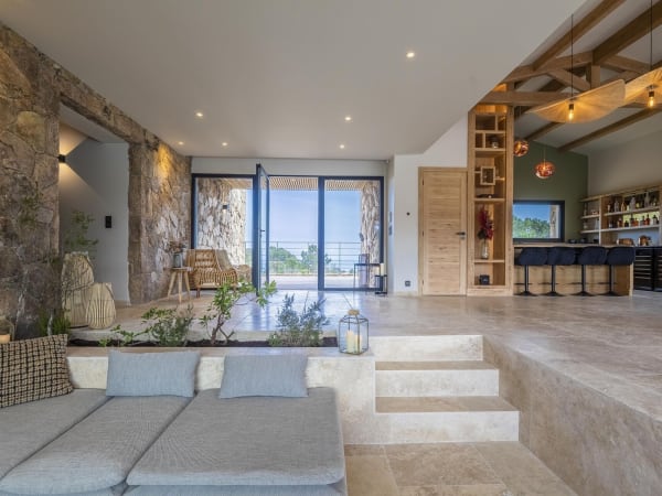 Looking from the sunken sitting area towards the main entrance and the kitchen.