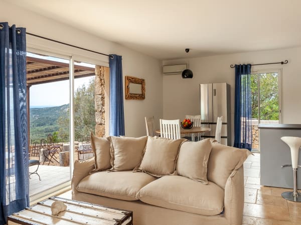 The bright, comfortably furnished open-plan living, dining and kitchen area.