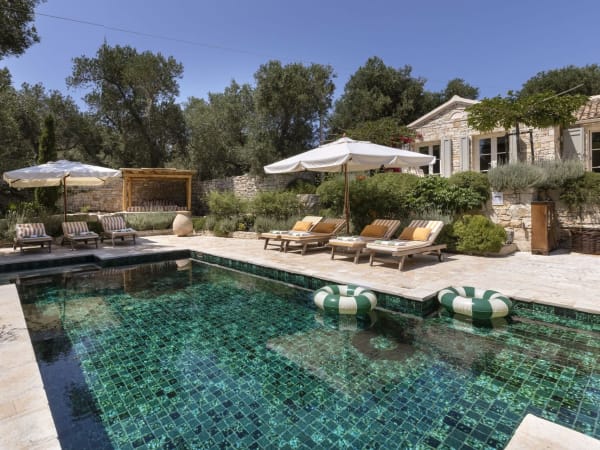 The pristine stone façade of Aperghis rising above the lovely pool.