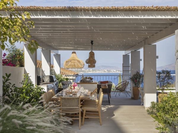 Catrine's gorgeous, shady al fresco dining area and kitchen with its views out to sea.