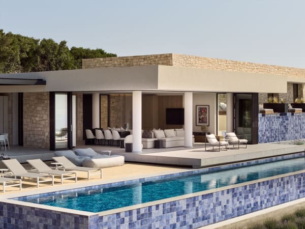 Sleek contemporary lines and walls of fully extendable windows opening out onto the terraces.