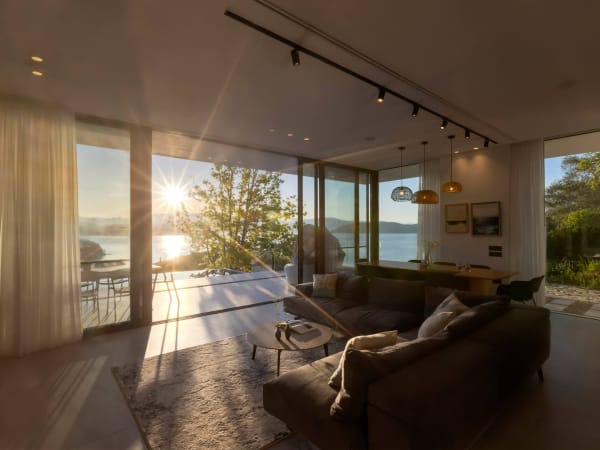 The luminous communal space with its wall of sliding glass doors and sea views.