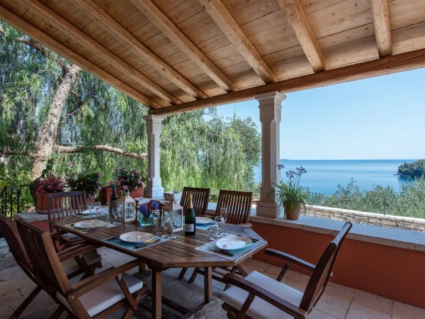 The main dining terrace overlooks the pool and the sea.