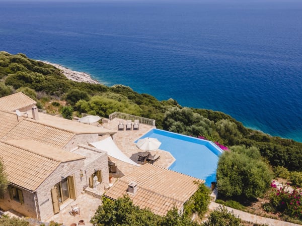 Looking down on the house, its pool and the sea.