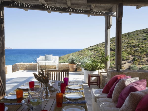 The shaded al fresco dining area outside the kitchen and the open-plan living and dining area.