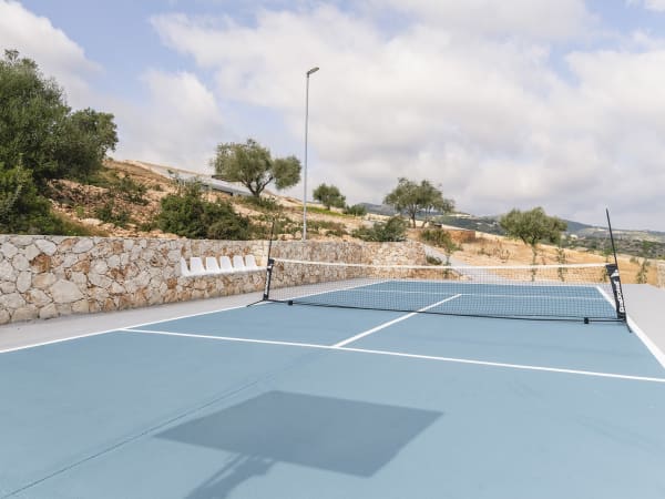 A mini tennis court with basketball hoop is perfect for sports lovers.