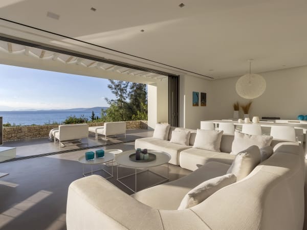The living and dining area with its fully retractable sliding glass walls.