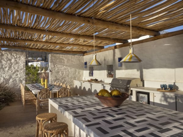 The convivial al fresco dining area is served by an outdoor kitchen and barbecue.